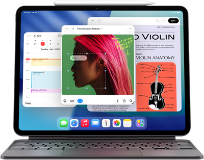 iPad Air zobrazující plochu s různými aplikacemi Apple, spárovaný s Magic Keyboardem a Apple Pencilem Pro