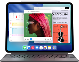 iPad Air zobrazující plochu s různými aplikacemi Apple, spárovaný s Magic Keyboardem a Apple Pencilem Pro