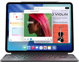 iPad Air zobrazující plochu s různými aplikacemi Apple, spárovaný s Magic Keyboardem a Apple Pencilem Pro